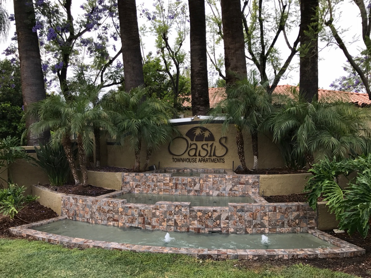 The same water feature before the remodel, with dated tile and murky water